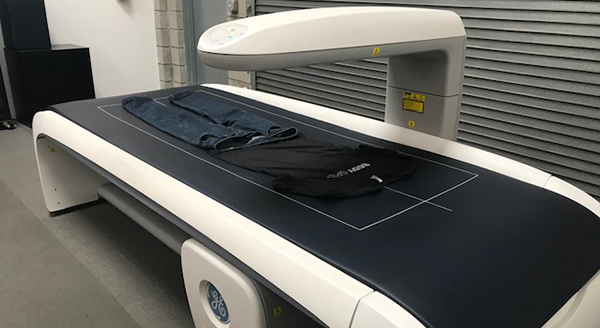 Picture of t-shirt and jeans on the DXA scanner.