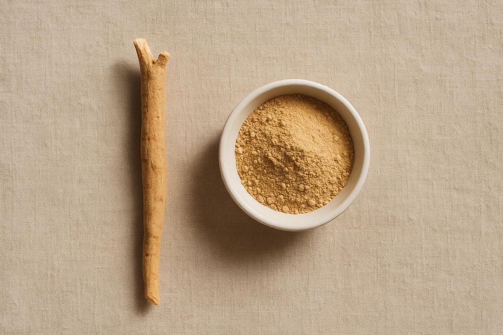 An Ashwagandha root lying next to a small white bowl filled with Ashwagandha powder, all on a light brown fabric background.