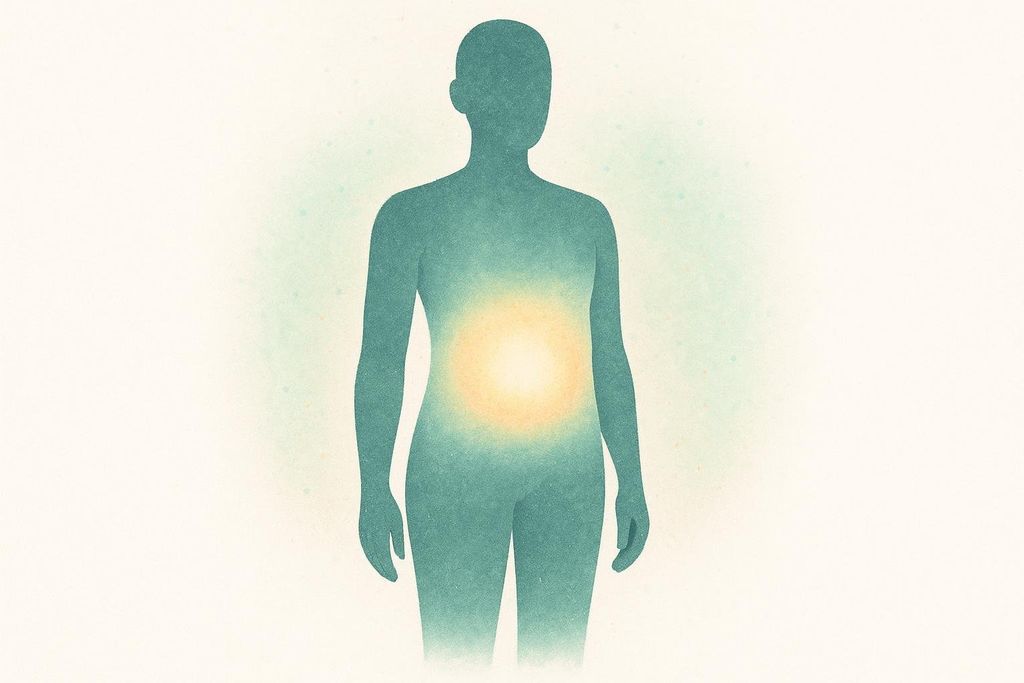 A stylized human silhouette in teal tones, with a bright yellow-orange glow emanating from the central core or stomach area. The image suggests a highlight on the torso or a pain point.