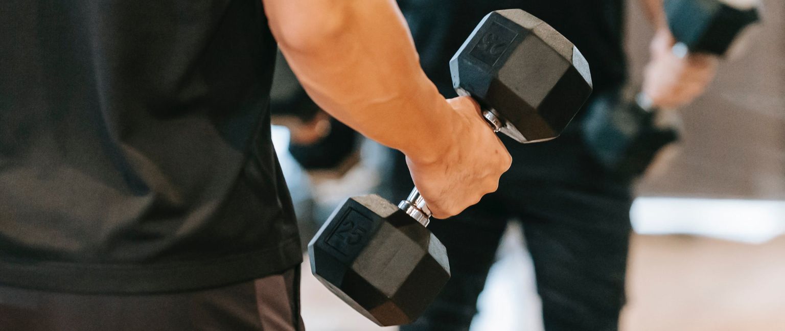 Close-up shot of a hand holding a 25-pound dumbbell during a workout.