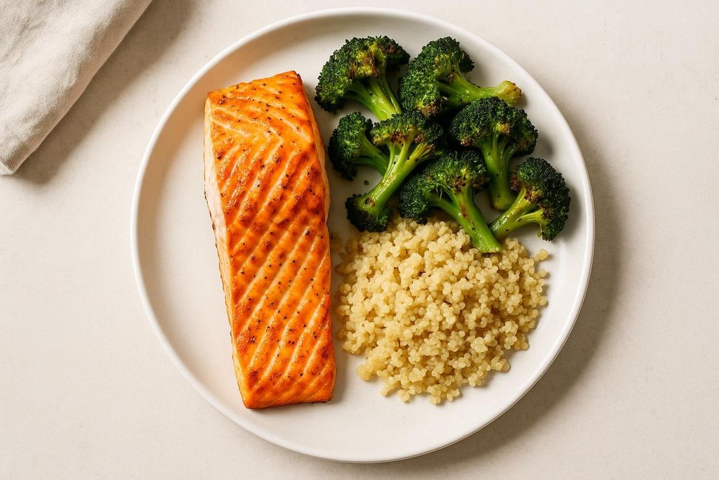 Flat lay of a healthy meal: salmon, quinoa, and roasted broccoli.
