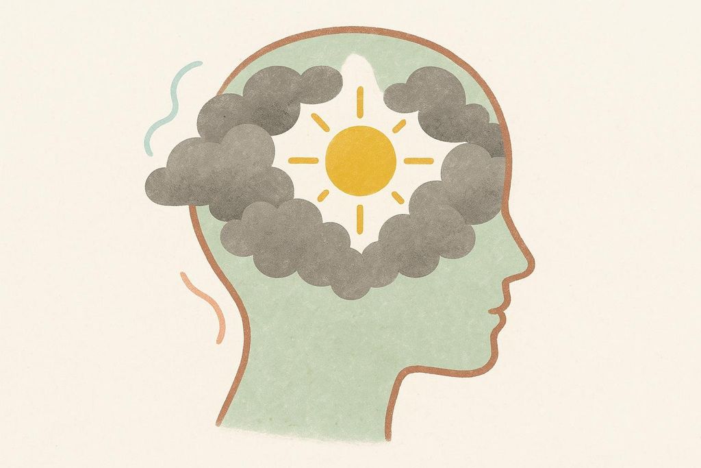 An illustration of a head silhouette with dark clouds inside, surrounding a bright yellow sun. This symbolizes brain fog clearing to reveal clarity.