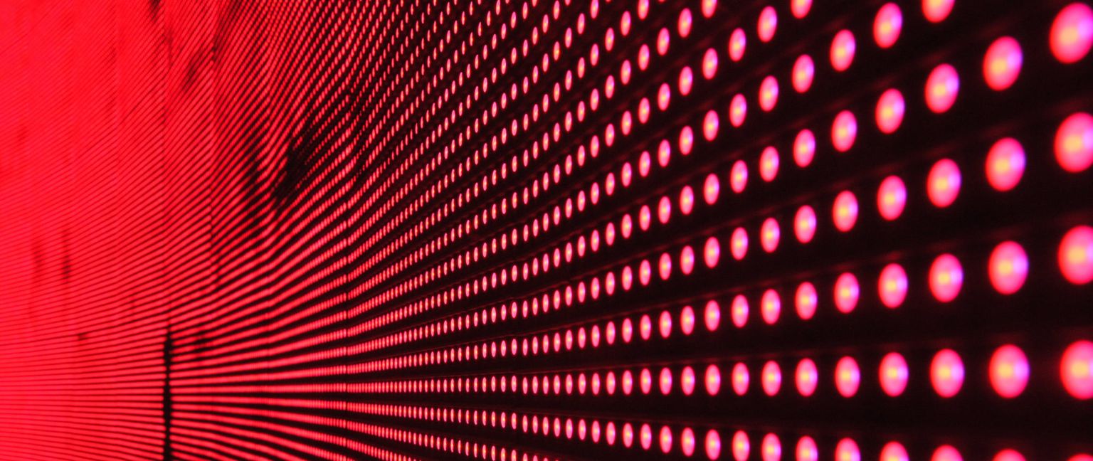 Close-up of a red LED screen showing a pattern of glowing red dots.