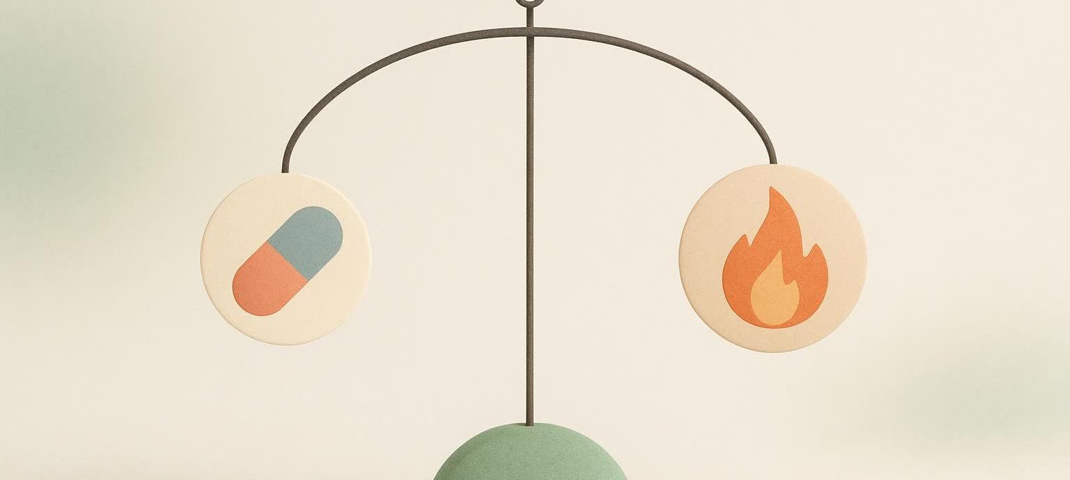 An illustration of a mobile sculpture. On the left, a pendant depicts a pill, and on the right, another pendant shows a flame. The two symbols are balanced on an arching bar, implying the concept of equilibrium or interaction between a medication and body's metabolism.