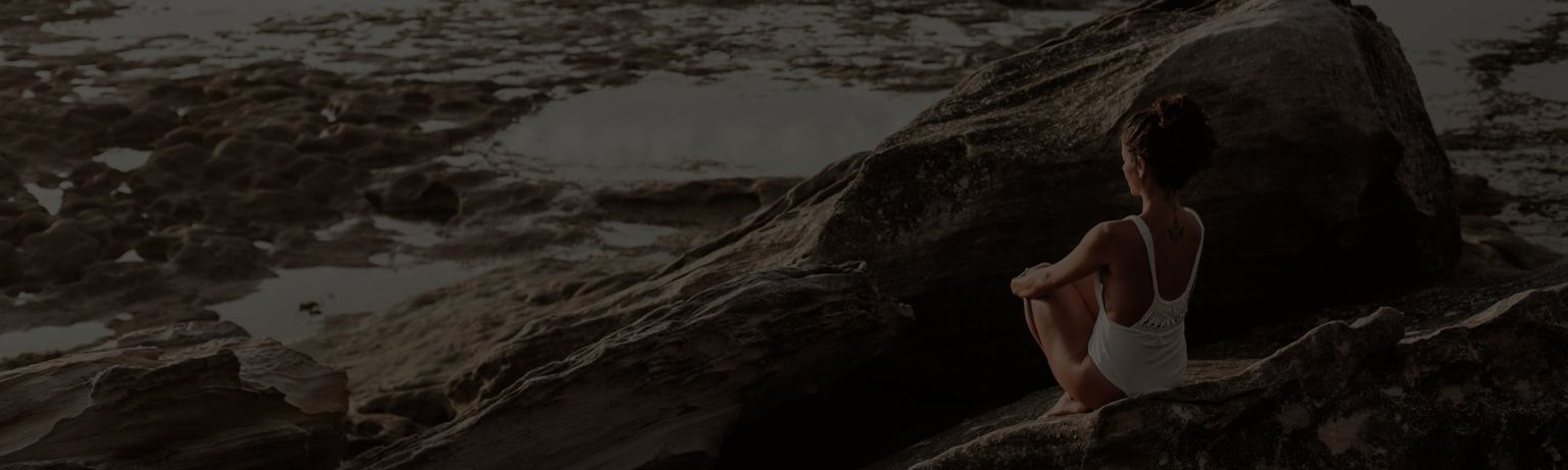 CoverShort: Woman Reflecting by Rocky Beach Desktop