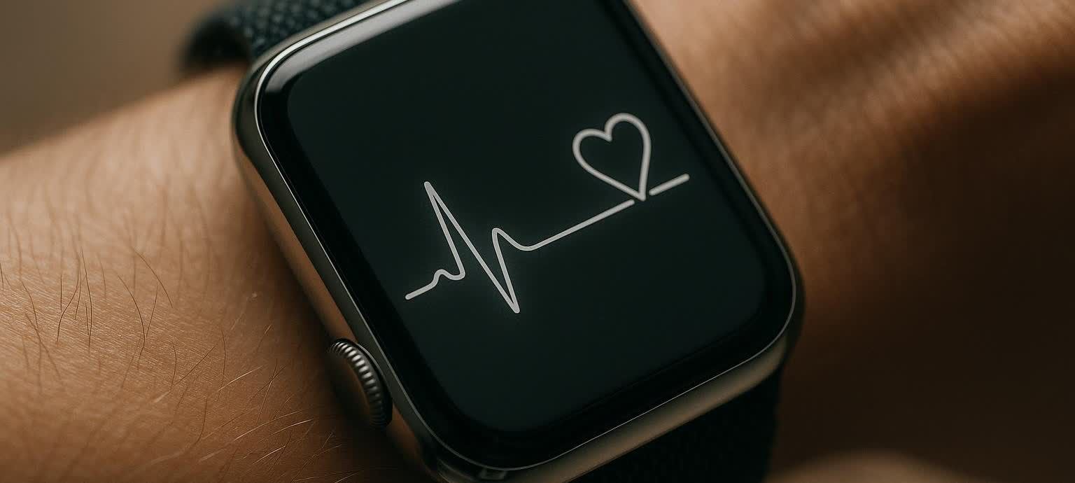 A close-up of a smartwatch on a wrist, displaying a bright white heart rate graph with a heart outline on its dark screen.