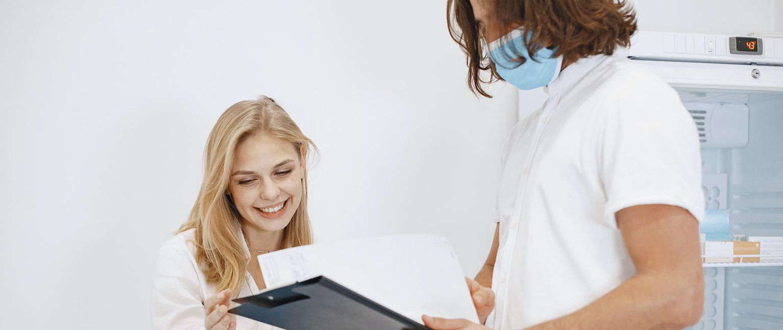 A doctor and patient looking at a medical report.