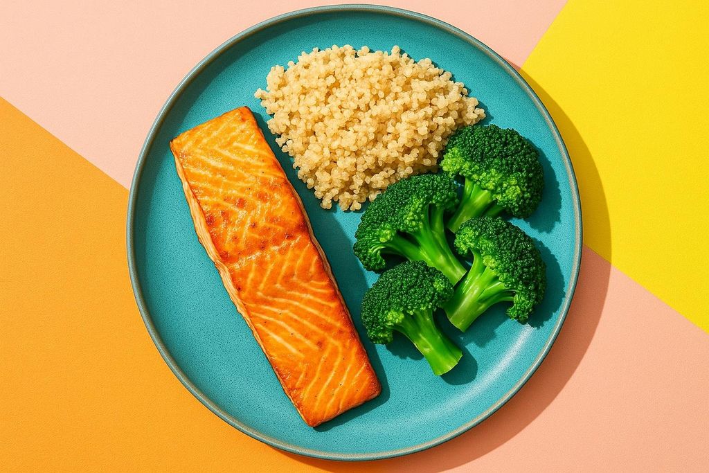 A plate of salmon, quinoa, and broccoli, presented from a top-down perspective.