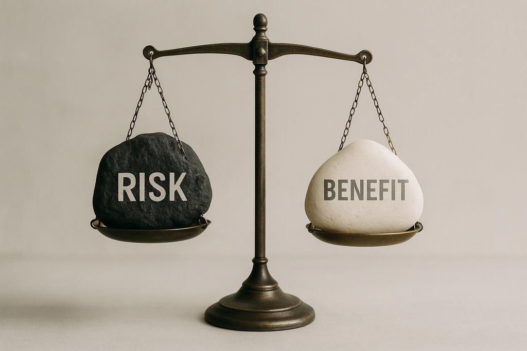 A balanced scale with a black rock labeled 'RISK' on one side and a white rock labeled 'BENEFIT' on the other.