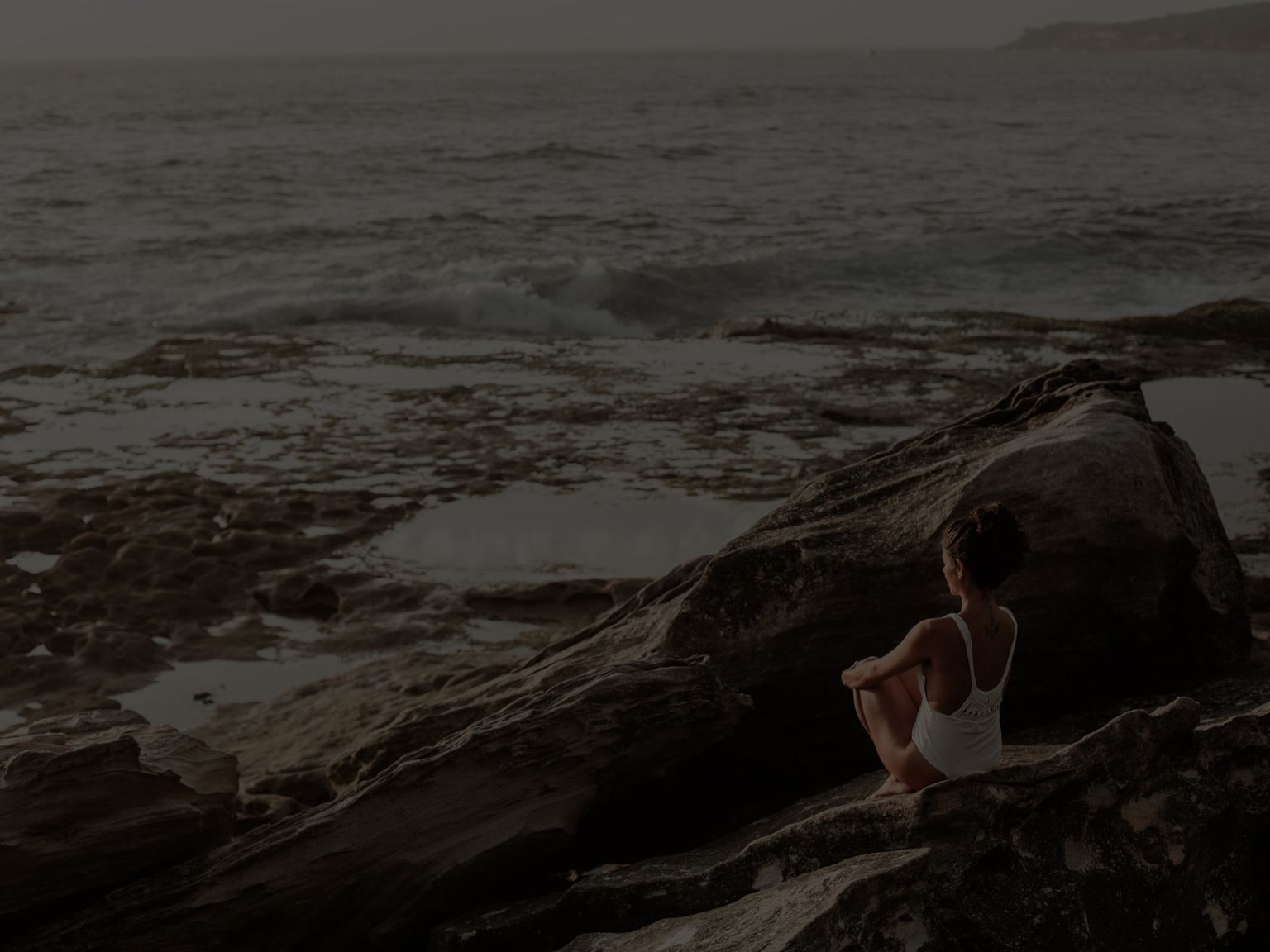 CoverShort: Woman Reflecting by Rocky Beach Mobile
